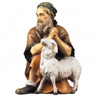 Shepherd kneeling with sheep