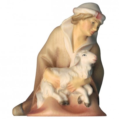 Shepherd kneeling with lamb